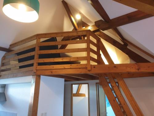 a loft bed in a room with wooden beams at Beautiful apartment in a bucolic, quiet setting in Viuz-la-Chiésaz