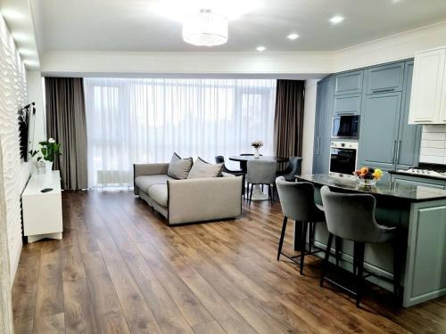 a living room with a couch and a table at The Central Collection Apartments in Chişinău