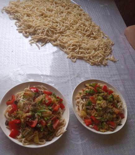 two bowls of pasta and vegetables on a table at Горное гнездо и юрты in Mineralʼnyy Istochnik Altyn-Arasan