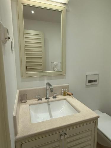 a bathroom with a sink and a mirror at Porto Marina Residence in Tivat