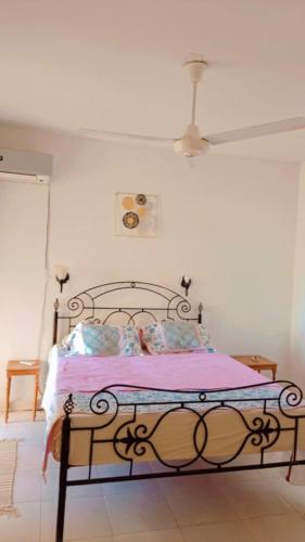 a bedroom with a bed in a white room at Romantic Chalete قرية الغرندل in Ras Sedr