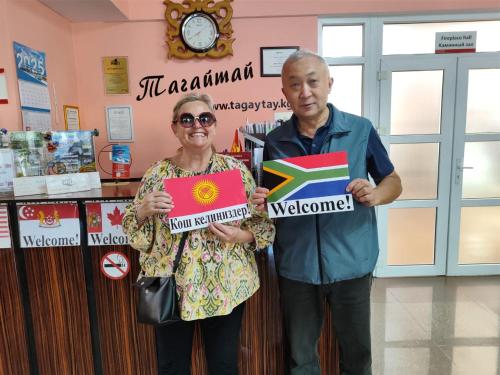 a man and a woman holding up a sign at Tagaytay Karakol Hotel in Karakol