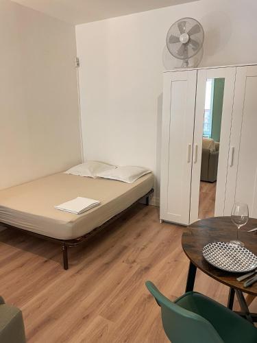 une chambre avec un lit, une table et des chaises dans l'établissement Escapade Ardéchoise - Parking Gratuit - Château à 2 pas, à Aubenas