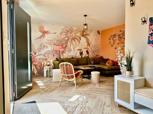 a living room with a couch and a table at La Maévague - Villa 4 étoiles - Voyage entre mer et monde in Fouras