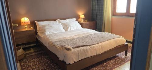 a bedroom with a bed with two night stands and two lamps at La Casa del Tramonto in Vellano