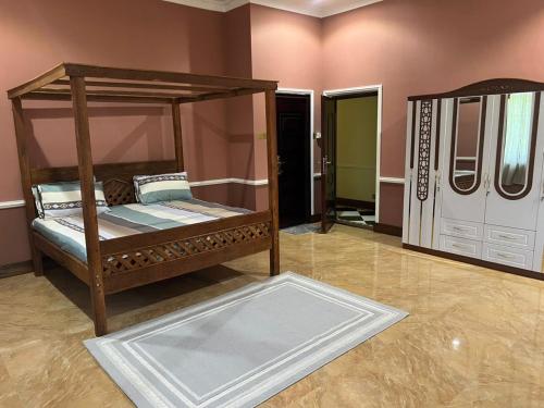 a bedroom with a canopy bed and a mirror at Entire Family home in Zanzibar City