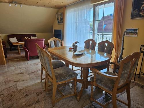 a dining room with a wooden table and chairs at Lehnert in Grube