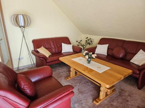 a living room with leather couches and a coffee table at Lehnert in Grube