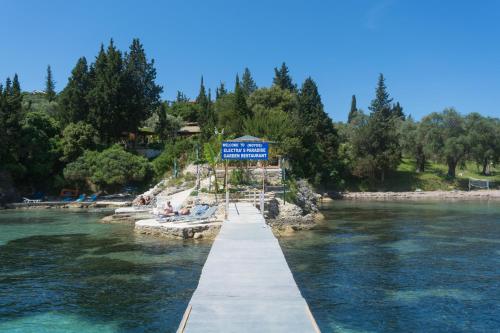 a dock in a river with people laying on the shore at Pension Elena in Ágios Nikólaos
