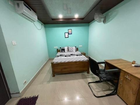 a room with a bed and a desk with a computer at Zion Apostolate in Athirappilly
