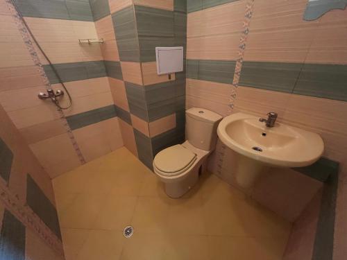 a bathroom with a toilet and a sink at Sea View Escape in Burgas