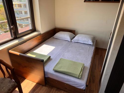 a small bed in a room with a window at Sea View Escape in Burgas