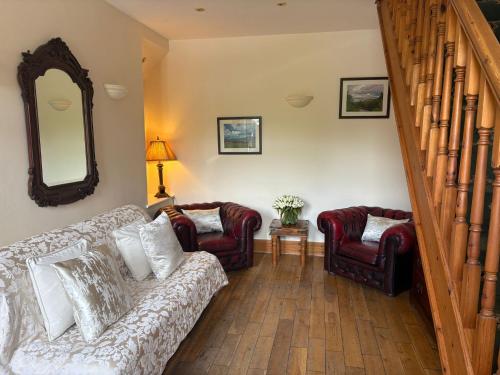 a living room with a couch and chairs and a mirror at Craig-Y-Nos Castle in Abercraf