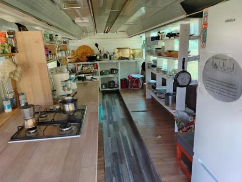 a kitchen with a stove in the middle of a room at La Busuri Camp in Roşia