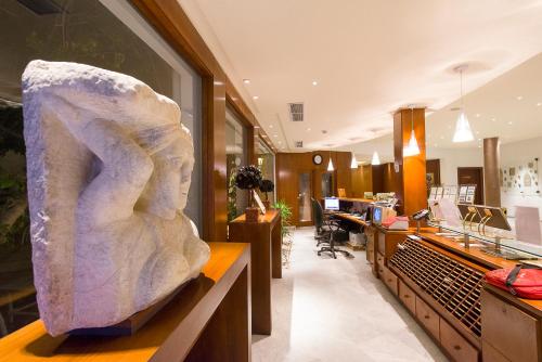a large stone statue sitting on a counter in a lobby at The Sindbad in Hammamet