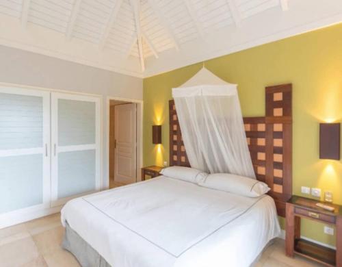 a bedroom with a large white bed in a room at Your Caribbean Style Villa in Petit Cul de Sac