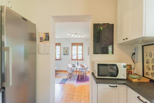 a kitchen with a table and a microwave at Casa Minù in Faggeto Lario 