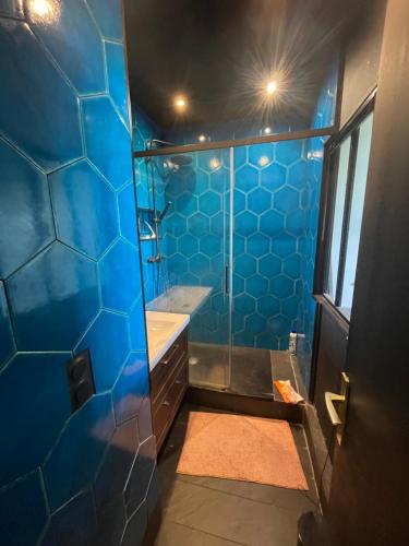 La salle de bains est pourvue de carrelage bleu, d'une baignoire et d'une douche. dans l'établissement Studio sur 2 plages , piscine et 3 personnes, à Biarritz