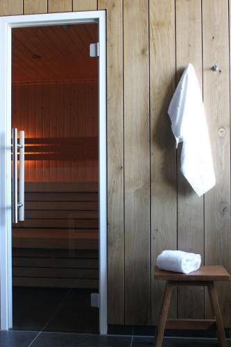 a towel hanging on a wall next to a door at Boutique Hotel Texel in De Cocksdorp