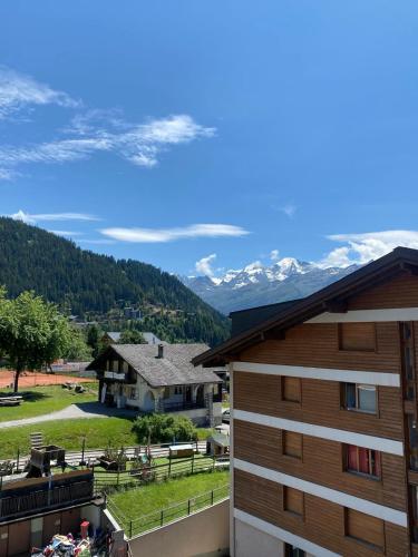 a view of the mountains from the balcony of a building at Asters 8 in Verbier