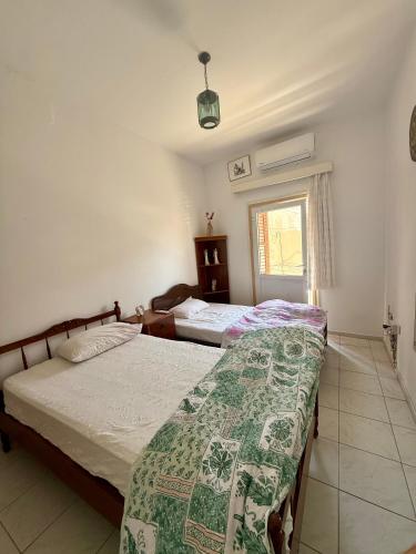 a bedroom with two beds and a window at Arsinoe Guest House in Famagusta