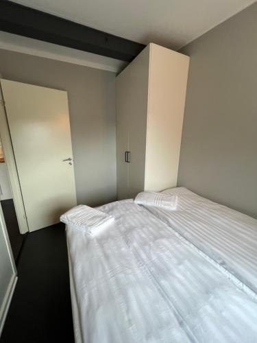 a small bedroom with a bed and a closet at La Mare Resort in Gothenburg