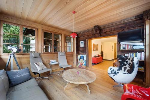 a living room with a couch and a table at chalet st Moritz 3 bdr terrace in St. Moritz