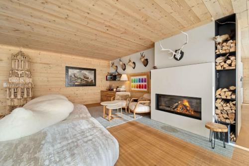 a bedroom with a bed and a fireplace at Chesa Wolf Zuoz in Zuoz