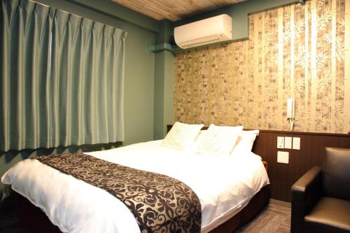 Postel nebo postele na pokoji v ubytování HOTEL neoWorld