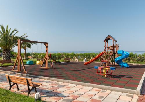 a playground with a slide and a slide at Sea Coast Resort Halkidiki in Yerakiní