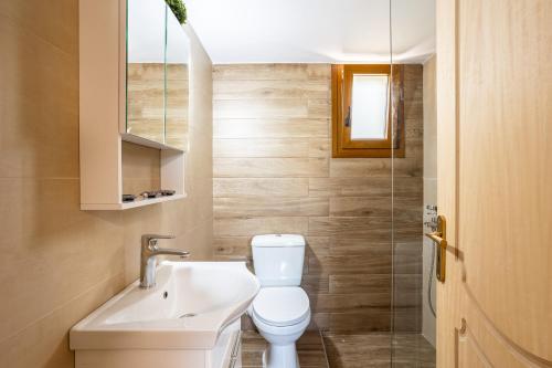 a bathroom with a toilet and a sink at Nelly's Place garden house 1 in Zakharo