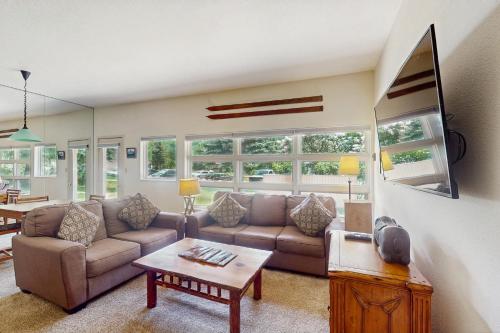 a living room with a couch and a table at Cozy 1 Bedroom East Vail Condo #2C. Shuttle, Hot Tub, and Market on Site. in Vail
