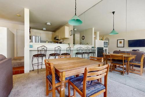 a dining room and kitchen with a table and chairs at Cozy 1 Bedroom East Vail Condo #2C. Shuttle, Hot Tub, and Market on Site. in Vail