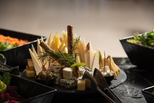 a plate of cheese and other foods on a table at Sea Coast Resort Halkidiki in Yerakiní
