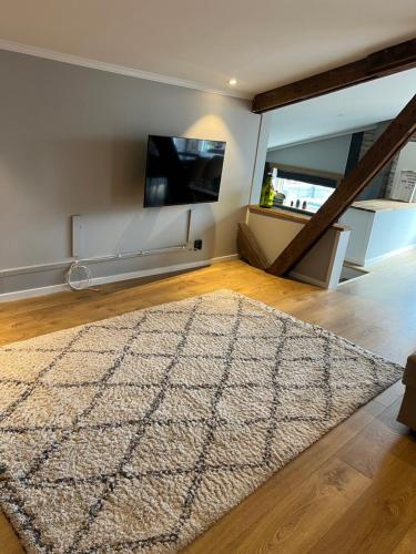 a living room with a rug on a wooden floor at La Mare Resort in Gothenburg