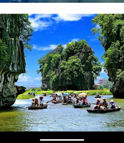 a group of people in boats on a river at Chilling Homestay - Hotel in Vũ Lâm
