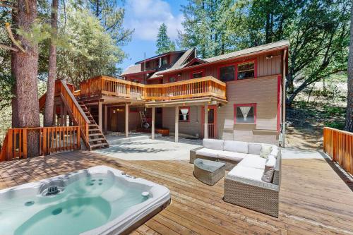 a large house with a hot tub on a deck at Wildwood Cottage in Idyllwild