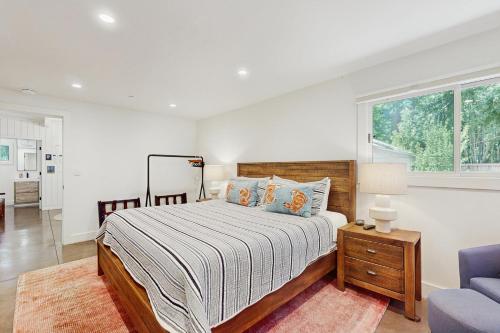 a bedroom with a bed and a couch and a window at Bearing Drive Escape in Tahoe City