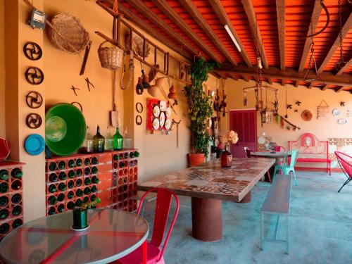 a room with tables and chairs and a room with wine bottles at Imperio de Memorias - Casa de Campo in Vale Bordalo