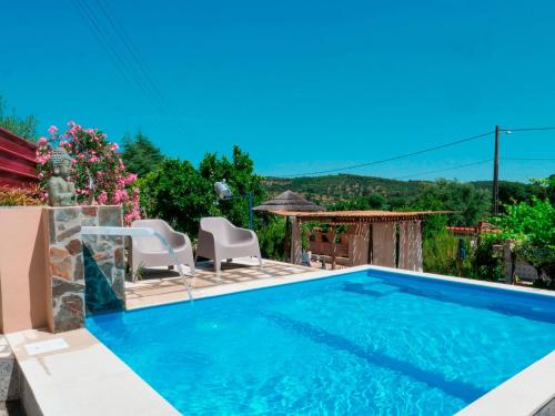 a pool with two chairs and a gazebo at Imperio de Memorias - Casa de Campo in Vale Bordalo