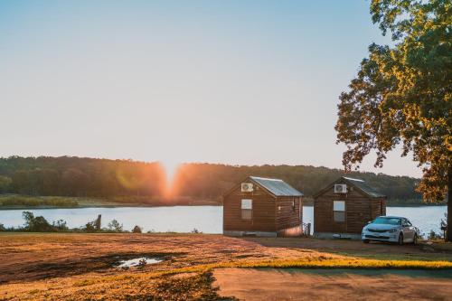 a cabin with a car parked in front of a lake at Lakeview Cedar Cabin - Kicks 66 - 4 in Mead
