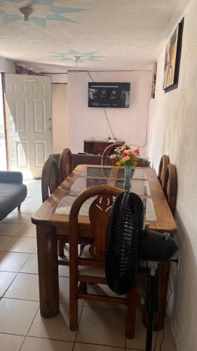 a dining room table and chairs with a table and aopter at Casa Cairo in San Juan del Río