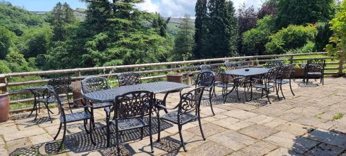a group of tables and chairs on a patio at Craig-Y-Nos Castle in Abercraf