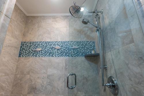a bathroom with a shower with a tiled shower at Fisherman's Wharf Inn in Boothbay Harbor