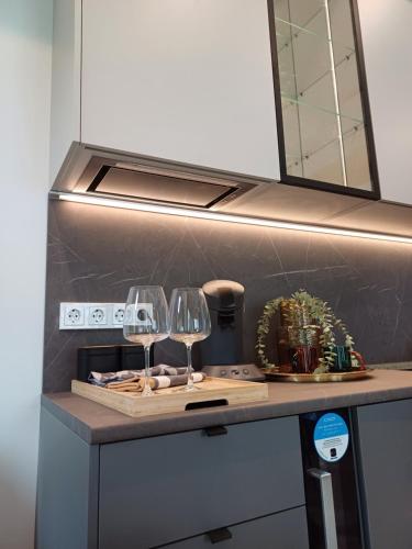 a kitchen with two wine glasses on a counter at Luise LuXe Suites in Tallinn