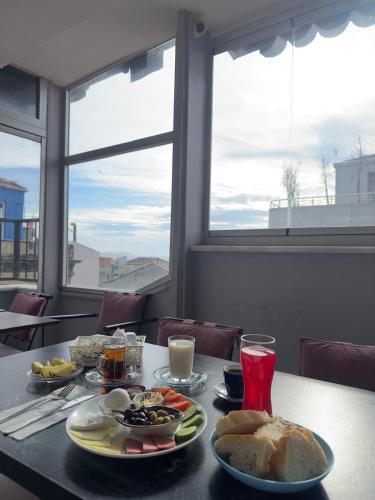 a table with plates of food on it with a window at Mitra Downtown Hotel in Istanbul