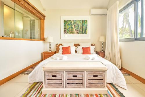 a bedroom with a large bed and a large window at SG17 Villa Sable Front de Mer in Palmar