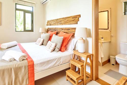 a bedroom with a large bed and a toilet at SG17 Villa Sable Front de Mer in Palmar