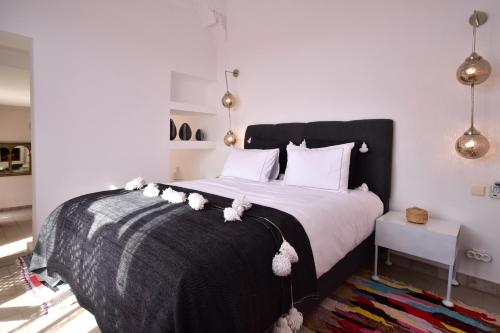 a bedroom with a bed with teddy bears on it at Dar Syada Boutique Hotel Marrakech in Marrakech