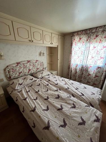 a bedroom with a bed with birds on it at Domek Czapla in Stare Sady